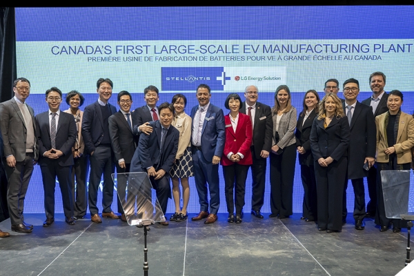 Group of people posting for photo on stage at business event