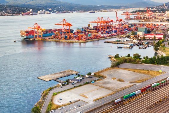 Large cargo loading cranes loading containers on ships in Vancouver harbor. 