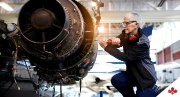 person working on aircraft turbine