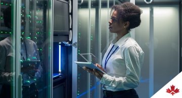 woman using tablet in server room