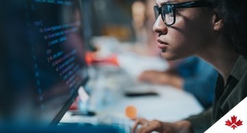 programmer reading computer codes on a desktop computer
