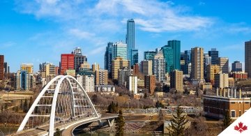 Edmonton downtown skyline showing Walterdale Bridge across Saskatchewan River and surrounding skyscrapers. 