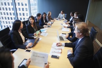 Multiracial group of work colleagues in a business meeting and discussing plans. 