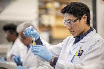 Young male laboratory technician working in a research facility.