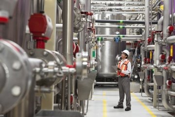 An engineer inspects a fuel storage facility.